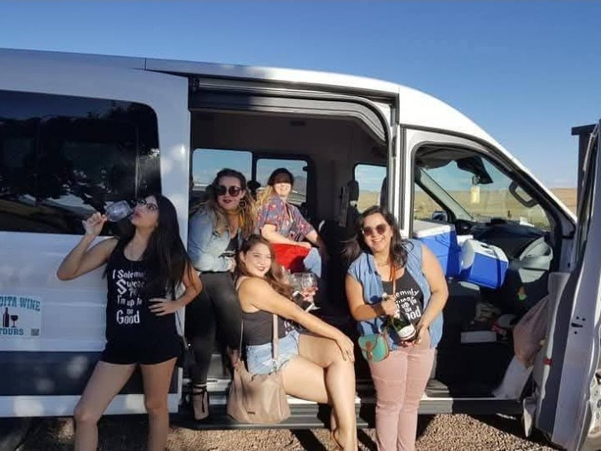 Guests posing with wine at the Sonoita Wine Tours van