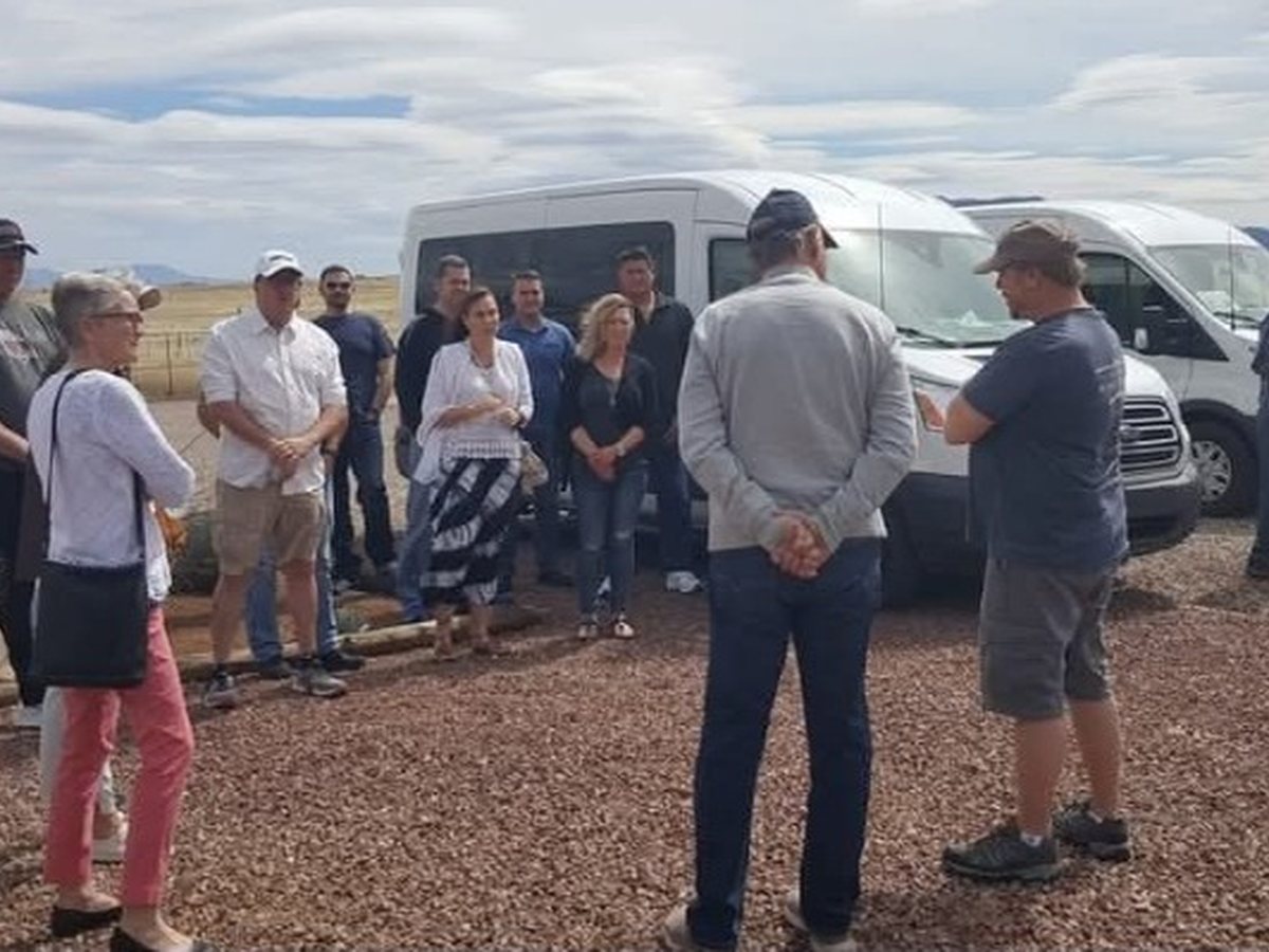 A tour group gathered by the Sonoita Wine Tours vans