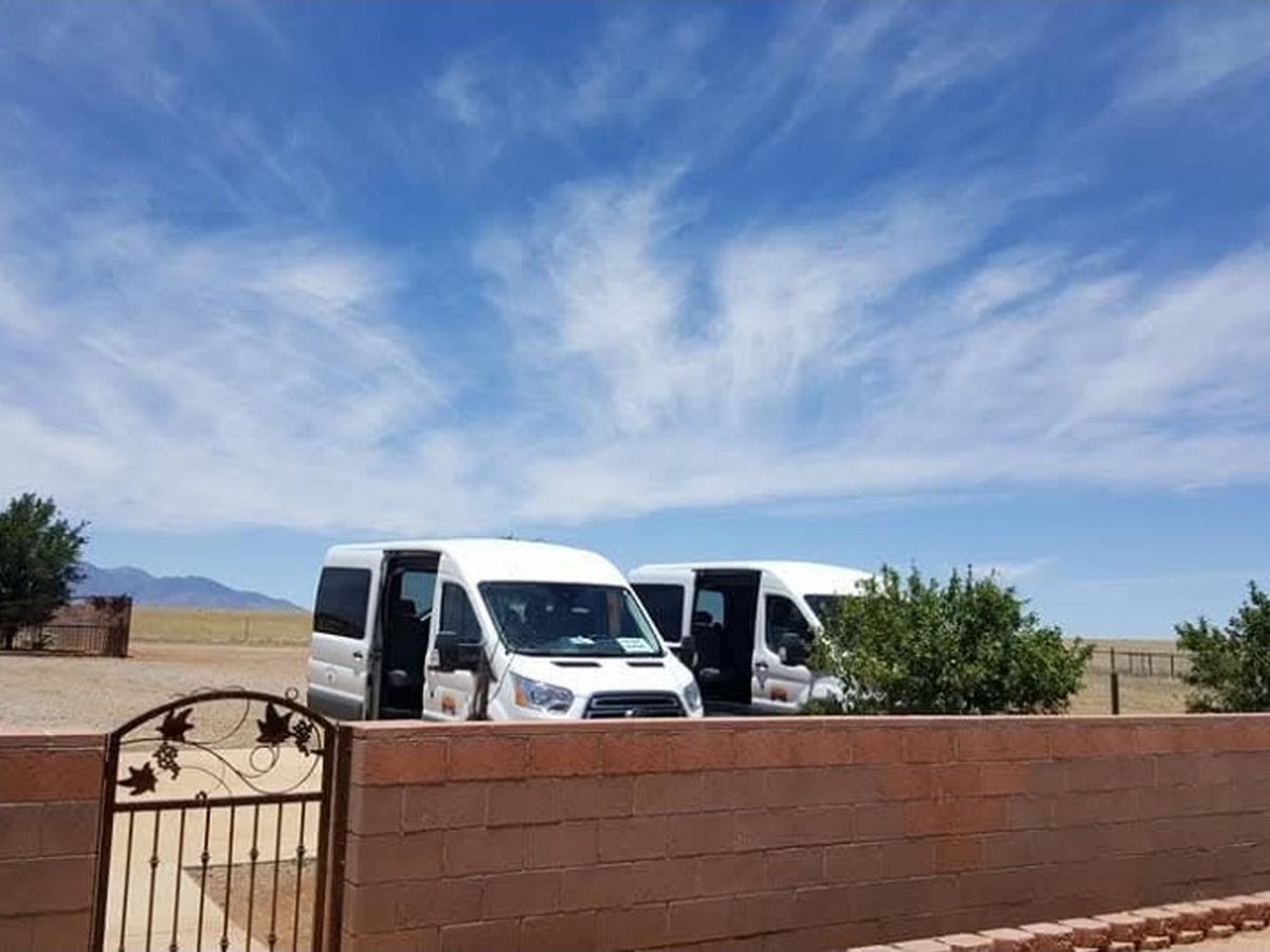 Sonoita Wine Tours vans parked in the Southern Arizona countryside